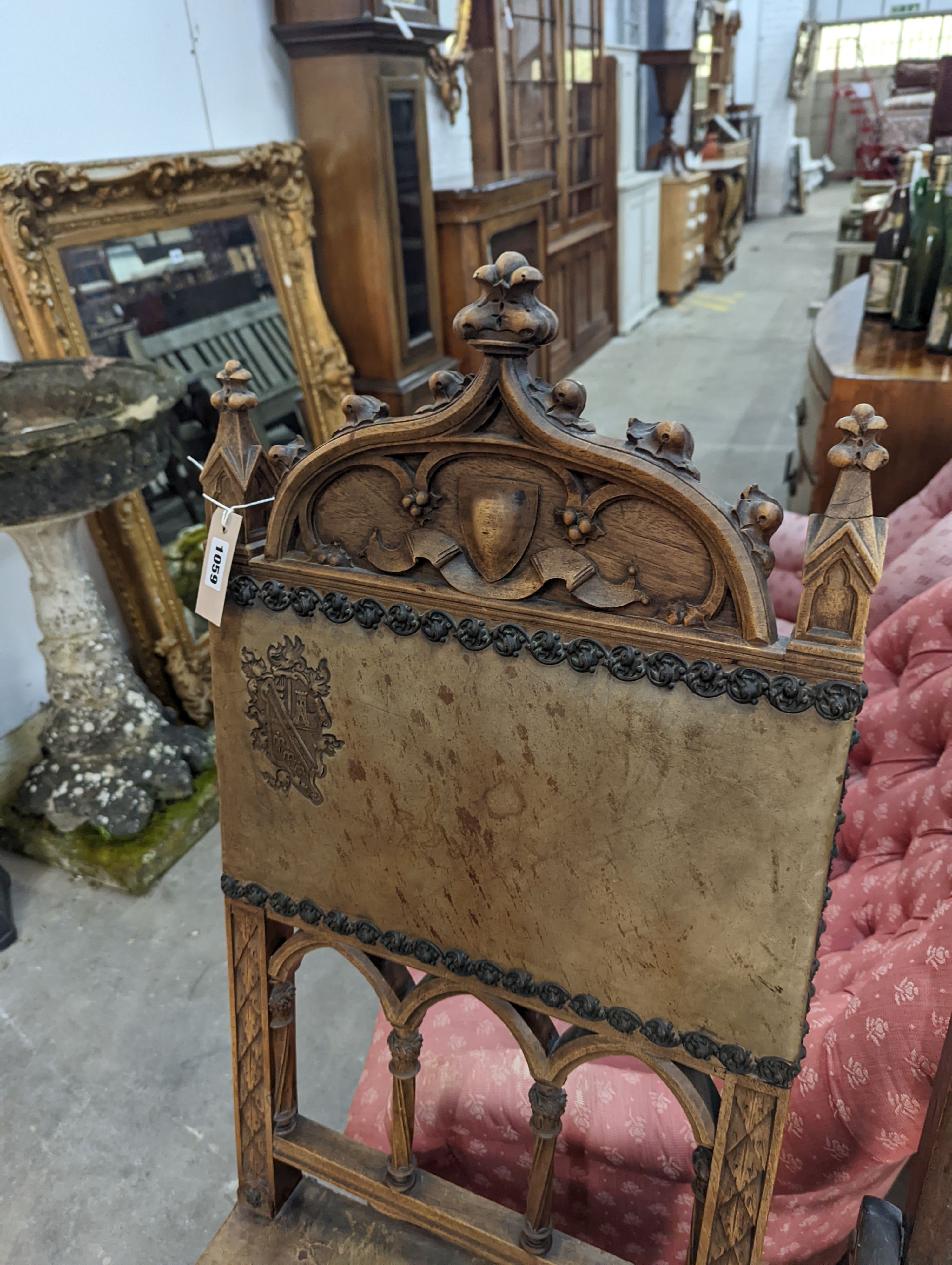 A pair of Gothic style carved walnut and leather side chairs together with an Edwardian beech folding chair